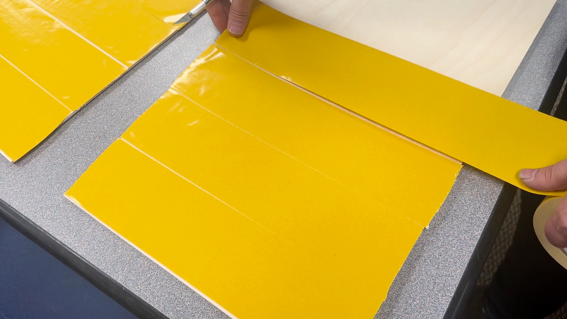 Applying backing tape to plywood