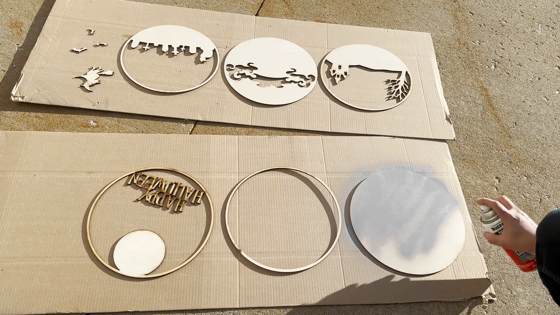Spray primer on plywood pieces