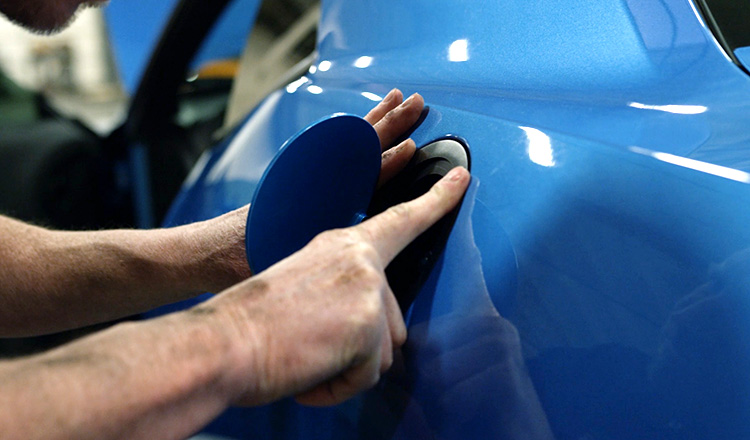 A car's fuel door being worked on the American Brother Designs workshop