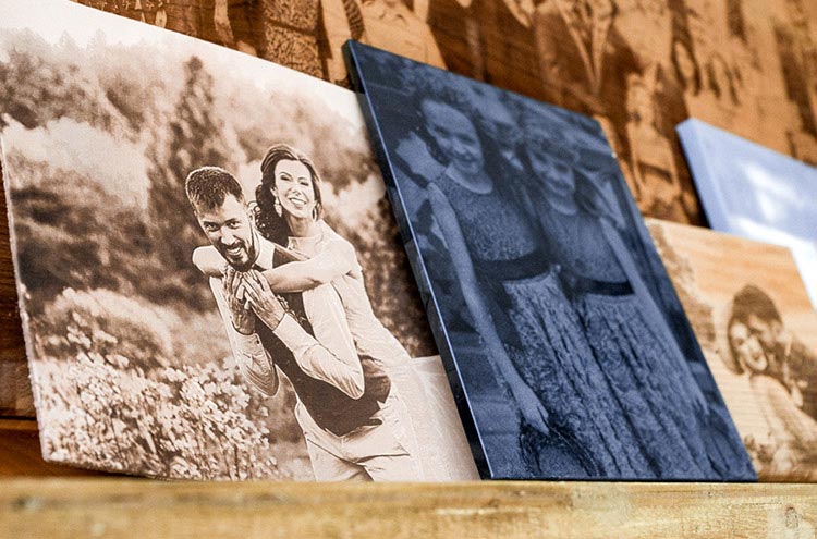 Group of wedding photos engraved on wood, leather, stone, and canvas