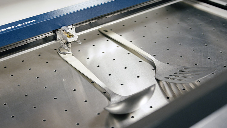 utensílios de metal num Epilog helix prontos a serem gravados a laser