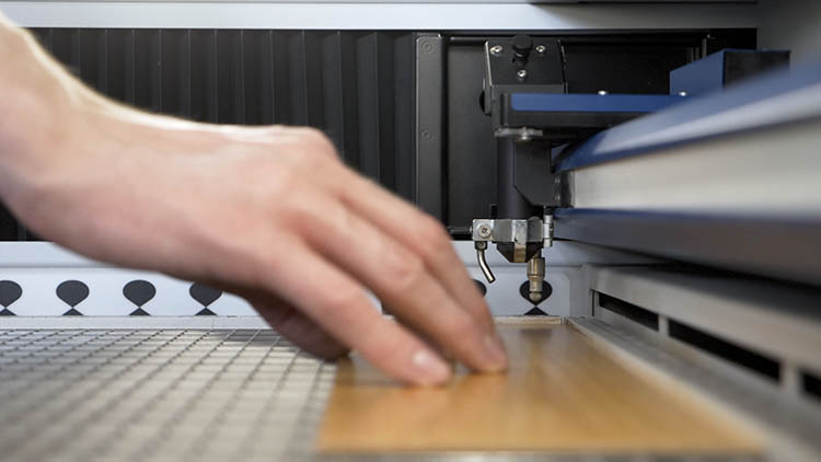 Placing wooden sheet in laser machine