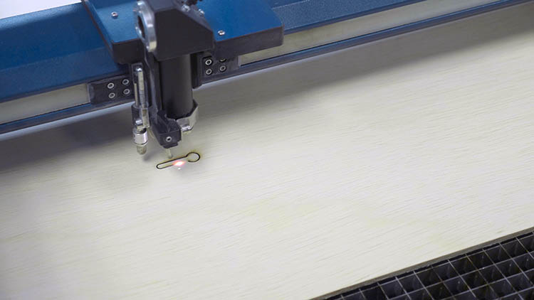 Epilog Laser machine cutting out a keyhole slot