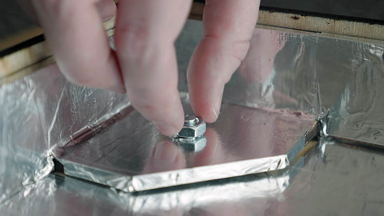 Securing a nut around one of the back panel bolts.