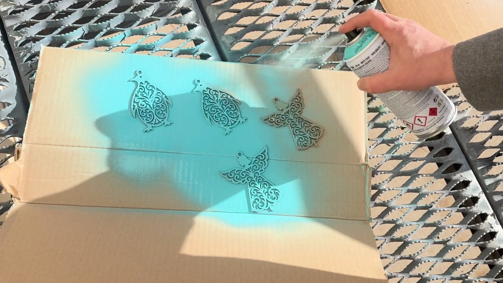 Spray painting laser cut Christmas ornaments