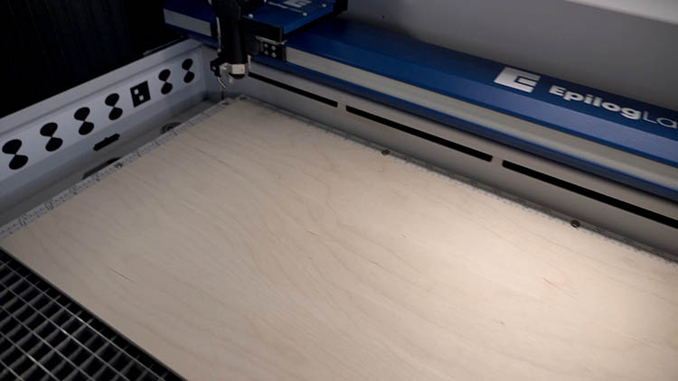 Placing plywood sheet in laser machine
