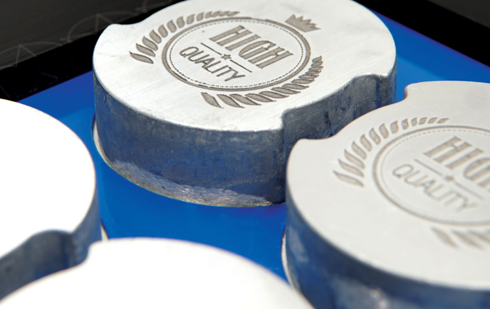 The G2 galvo can engrave a full table of metal parts at one time.
