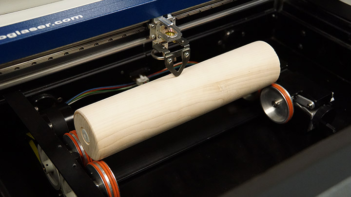 A rolling pin placed on a rotary device in the laser system