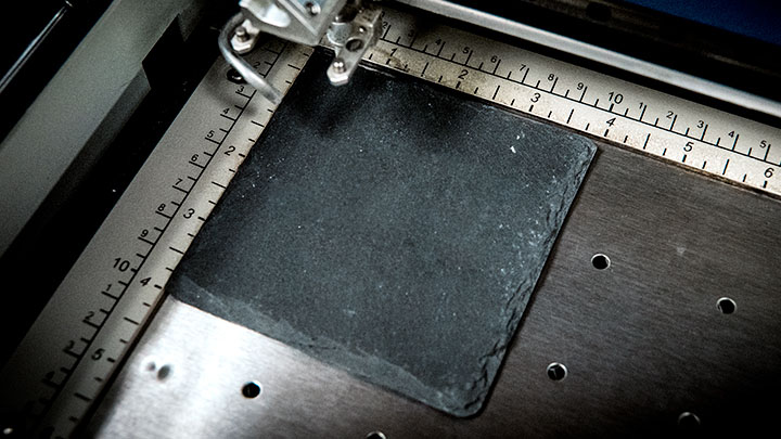 slate coaster placed in laser system