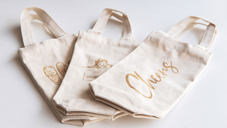 group of laser engraved canvas wine bags