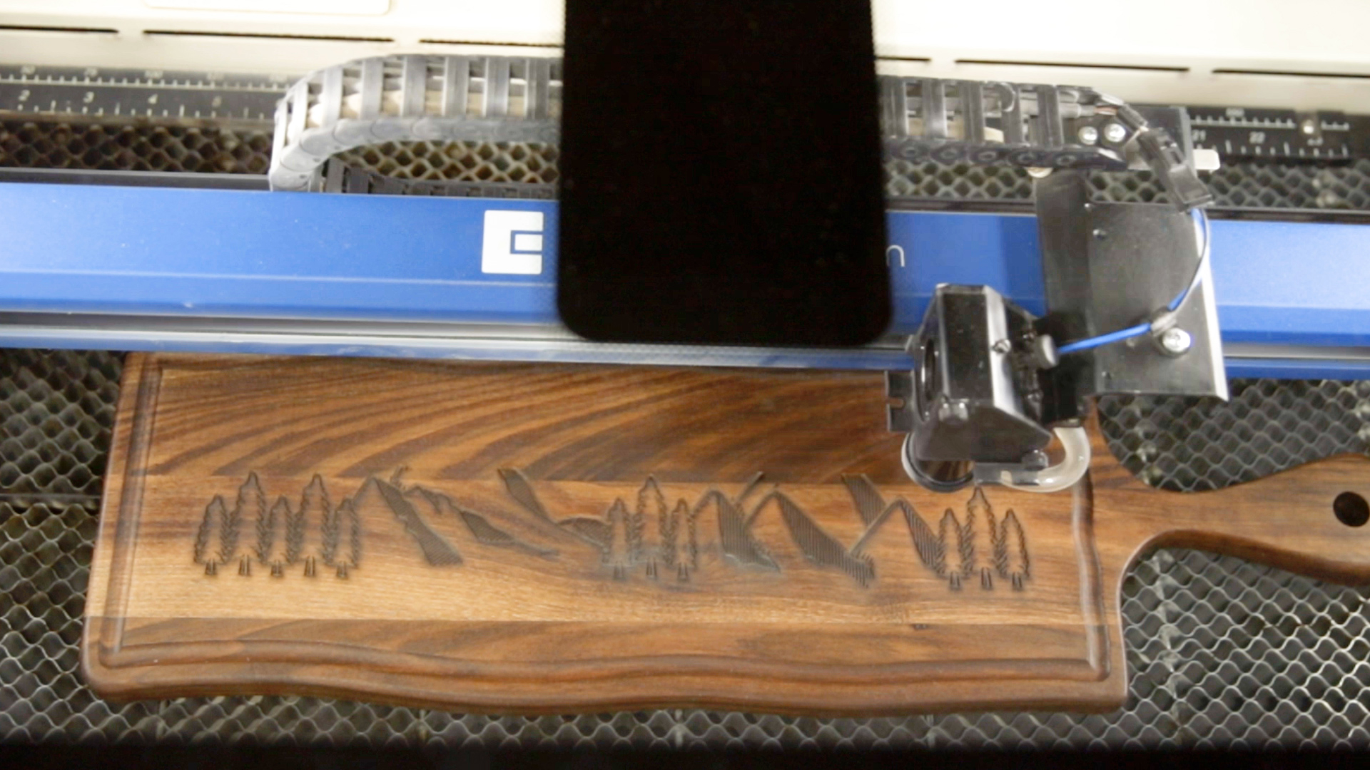 Position artwork to laser engrave wooden cutting board