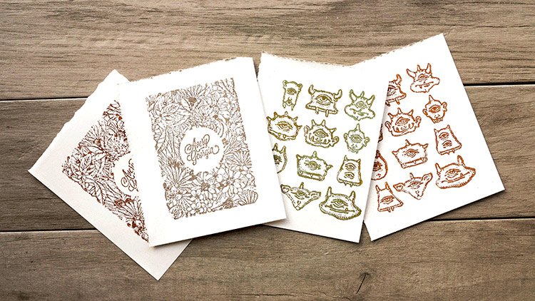 A spread of four prints made from laser engraved wooden stamps.