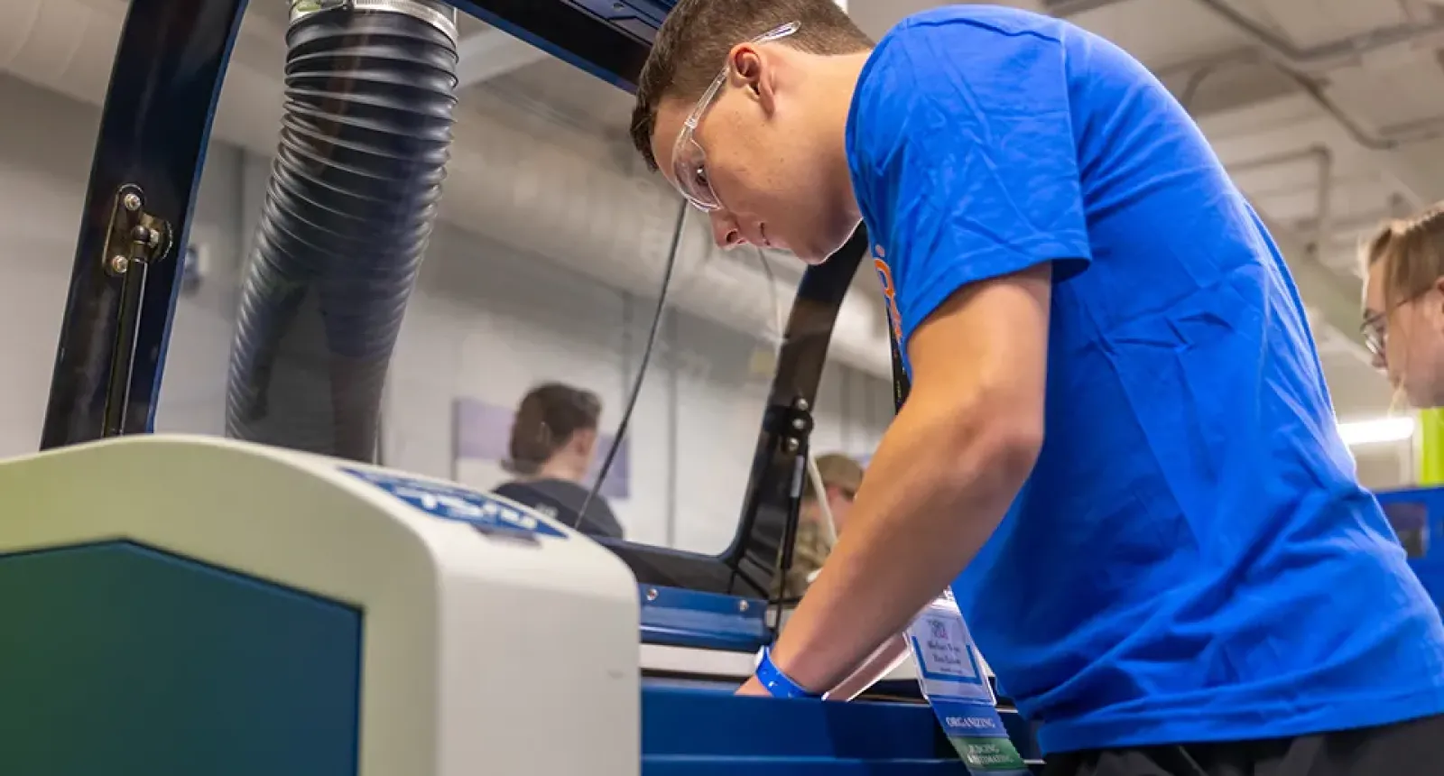 rice lake high school student working with an epilog laser machine