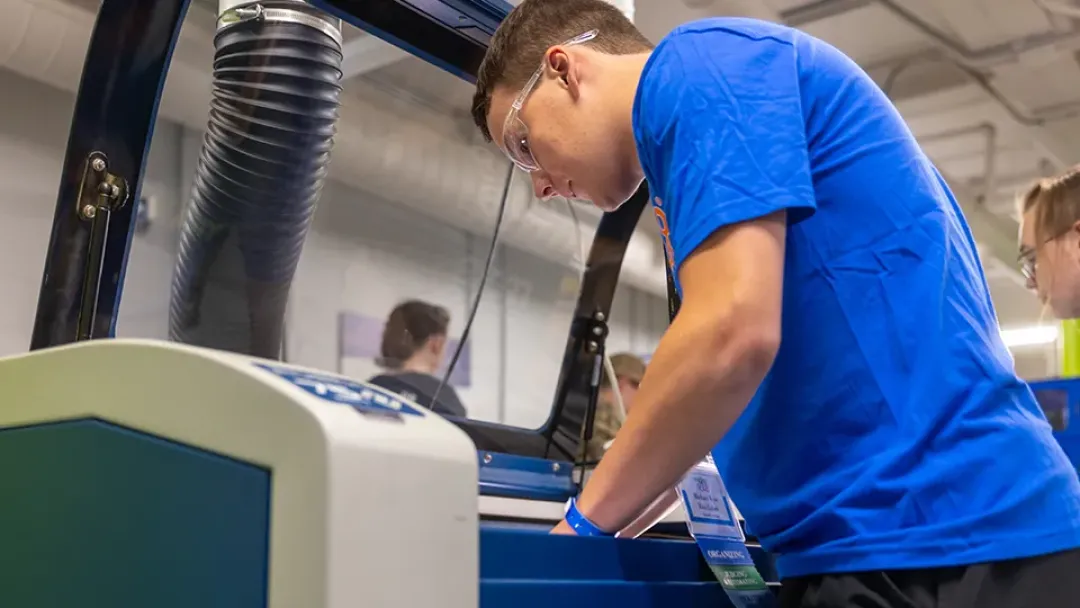 rice lake high school student working with an epilog laser machine