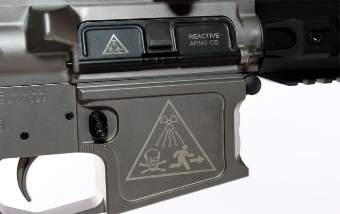 laser engraved ar-15 receiver with reactive arms branding and stylized radiation warning symbol